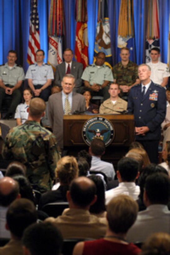 Secretary of Defense Donald H. Rumsfeld and Chairman of the Joint Chiefs of Staff Gen. Richard B. Myers, U.S. Air Force, listen to a question from an airman at a town hall meeting in the Pentagon auditorium on Aug. 14, 2003. Rumsfeld and Myers delivered opening remarks then fielded questions from military and civilian Pentagon employees. The forum allows people in the Pentagon to direct their questions to the leadership at the Defense Department. 
