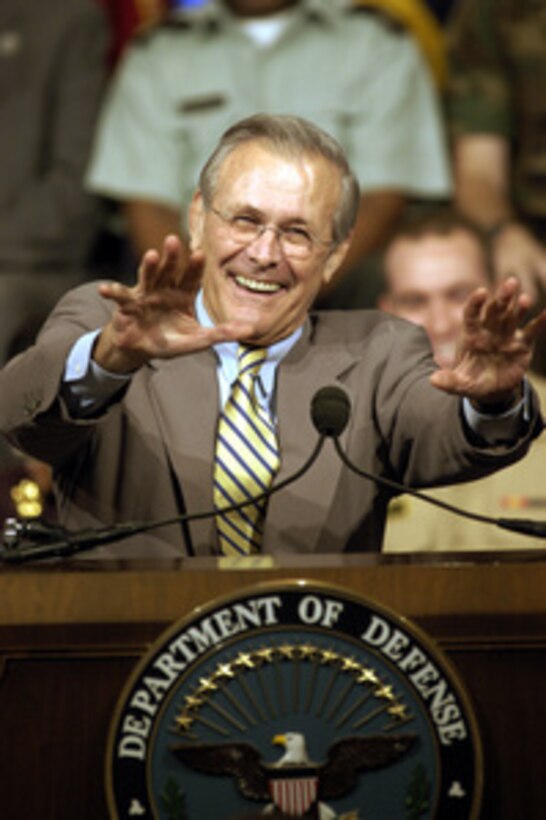 Secretary of Defense Donald H. Rumsfeld laughs as he answers a question at a town hall meeting in the Pentagon auditorium on Aug. 14, 2003. Rumsfeld and Chairman of the Joint Chiefs of Staff Gen. Richard B. Myers, U.S. Air Force, delivered opening remarks then fielded questions from military and civilian Pentagon employees. The forum allows people in the Pentagon to direct their questions to the leadership at the Defense Department. 