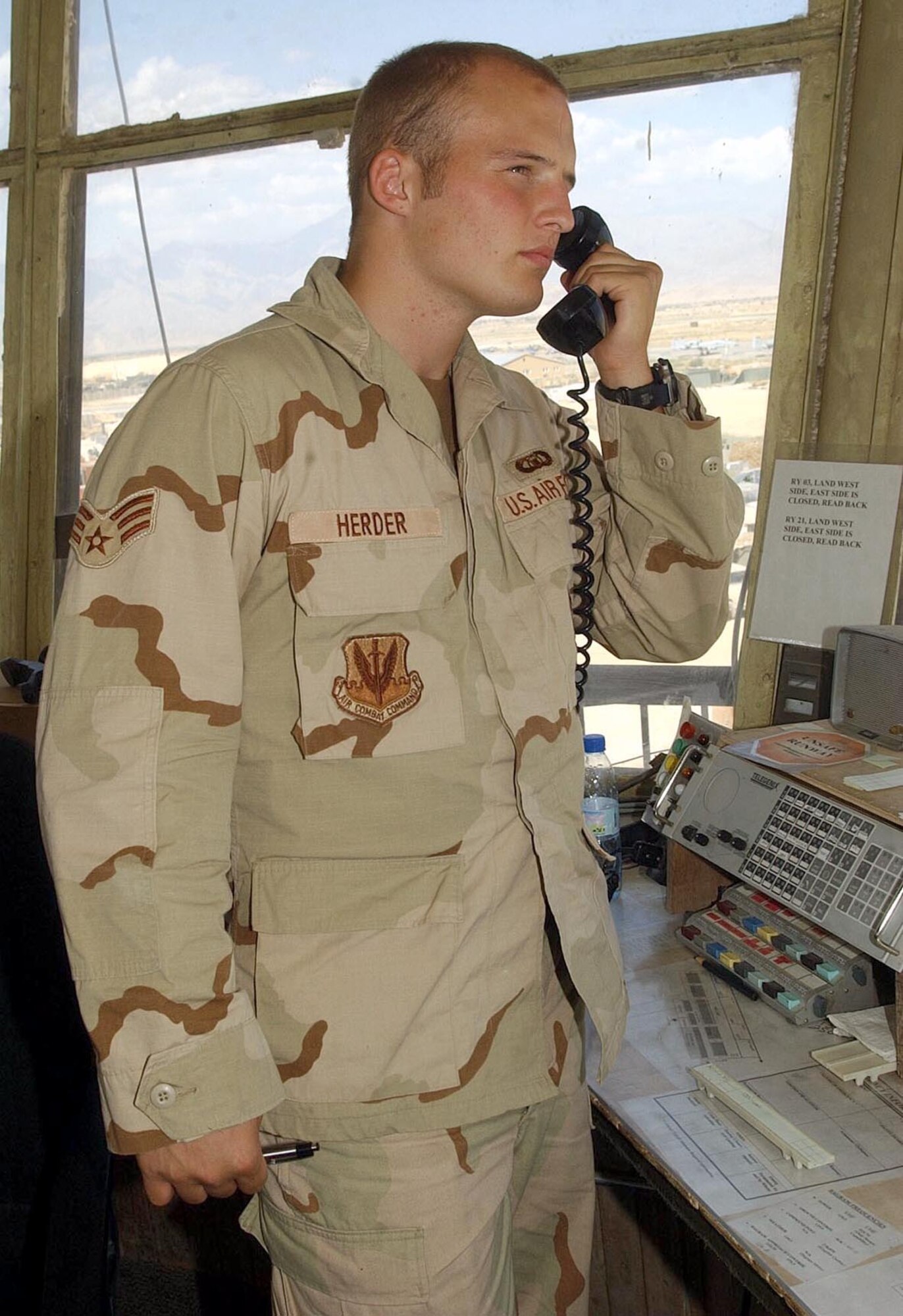 BAGRAM AIR BASE, Afghanistan - Senior Airman Jason Herder, 455th Expeditonary Operations Group, talks an aircraft in for a landing on the runway here Aug. 13.  (U.S. Air Force photo by Staff Sgt. Russell Wicke)