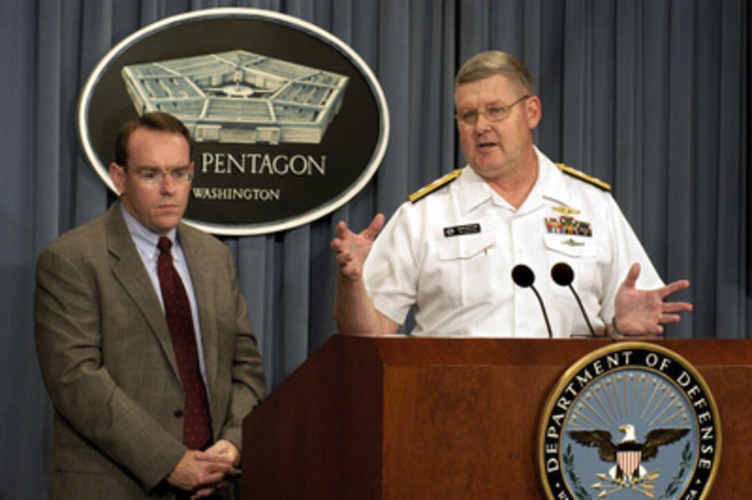 Navy Rear Adm. John Butler responds to a technical question from a reporter during an Aug. 14, 2003, Pentagon press briefing on the details of a newly signed contract to acquire six Virginia Class submarines. Butler and Assistant Secretary of the Navy for Research, Development, and Acquisition John J. Young Jr. (left) briefed reporters on the groundbreaking contract signed with General Dynamics Electric Boat Corp., in partnership with Northrop Grumman's Newport News Shipbuilding. Upon Congressional authorization and appropriation, the contract, valued at up to $8.7 billion, will award one submarine per year from 2003 through 2006 and two submarines in 2007. Butler is the submarine program executive officer. 