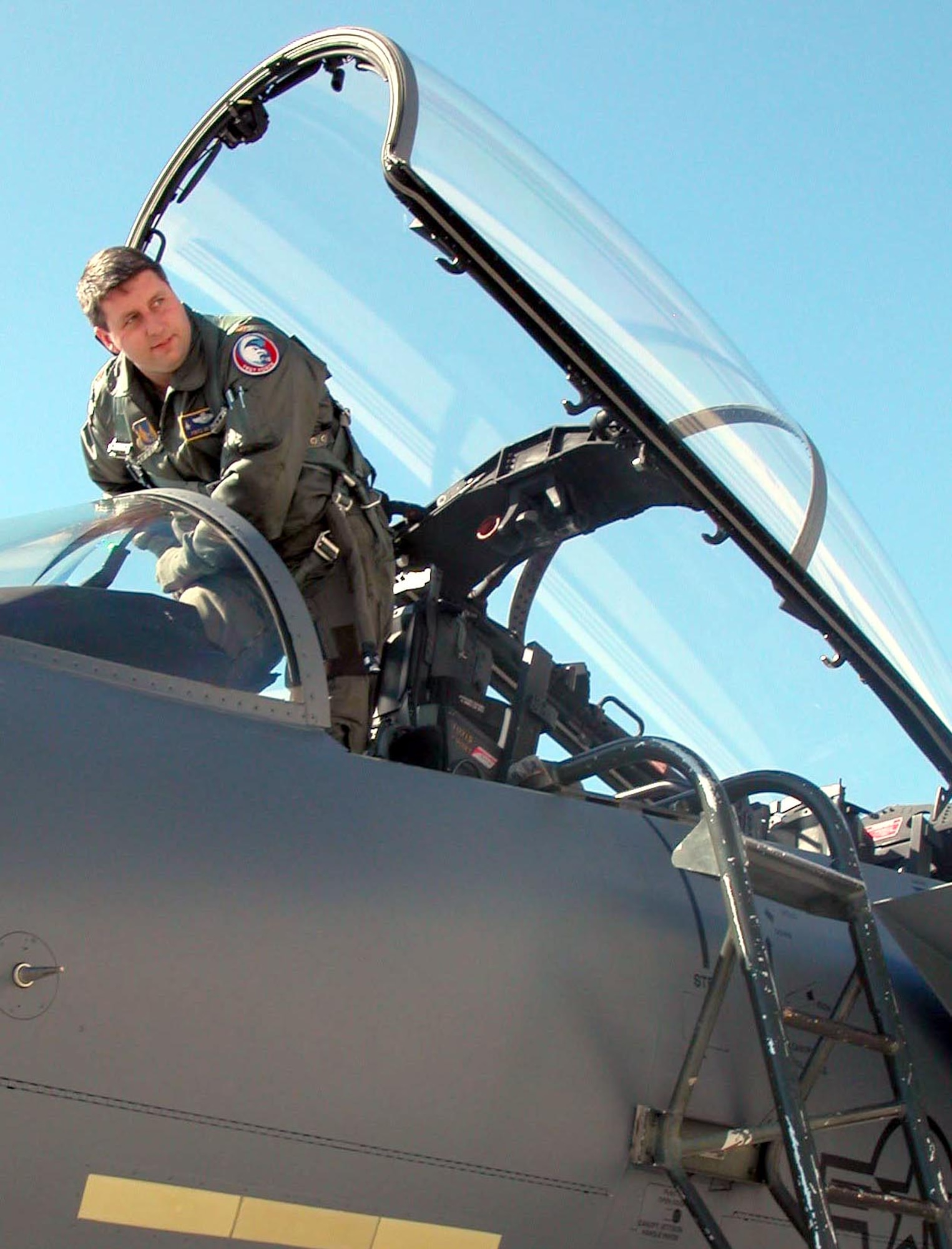 ROBINS AIR FORCE BASE, Ga. -- Maj. Fritz Heck, 339th Flight Test Squadron, exits an F-15 Eagle.  He praised the craftsmanship of the F-15 canopy shop here, which repairs flaws in F-15 canopies and windscreens.  (U.S. Air Force photo by Sue Sapp)
