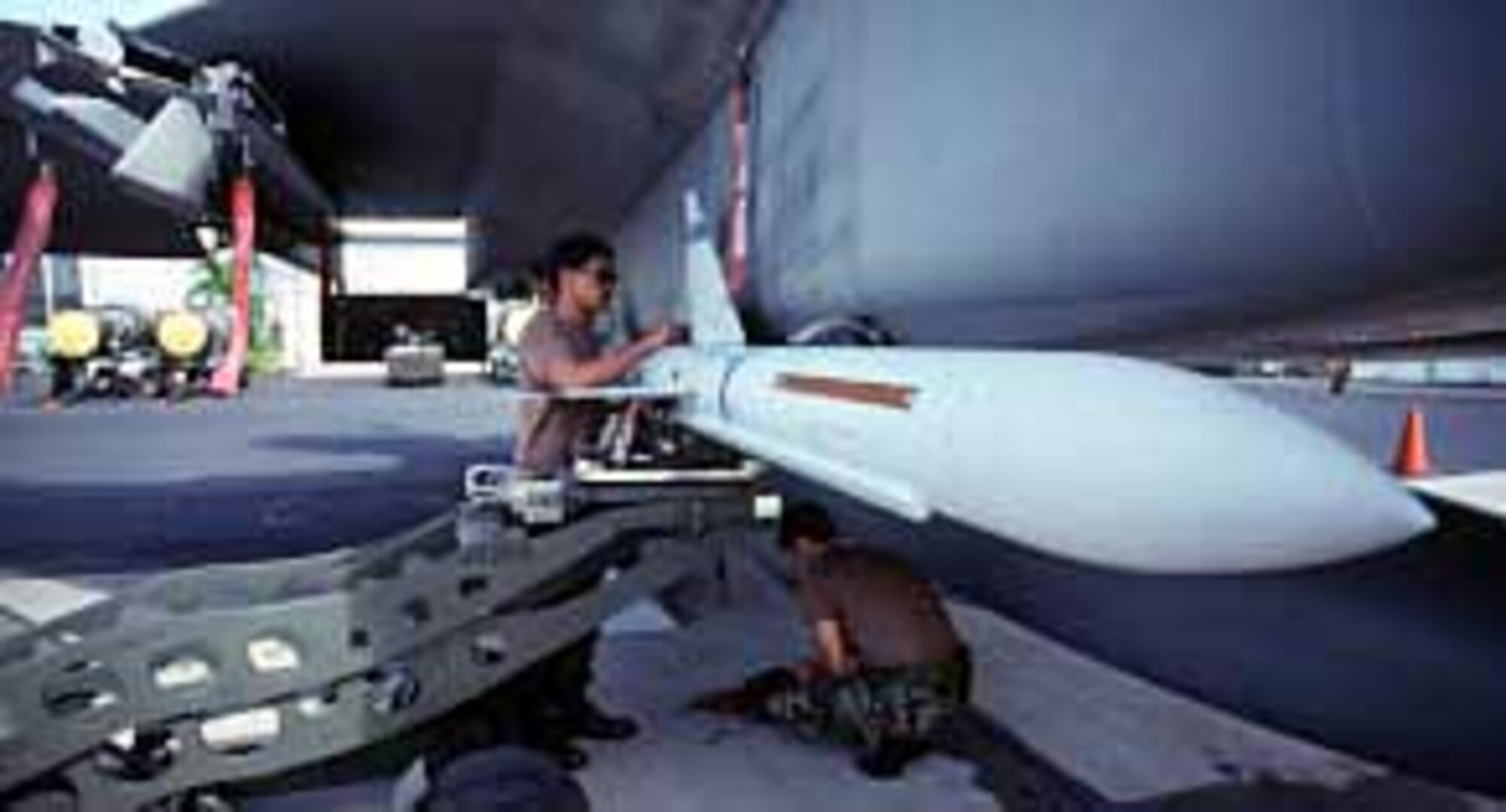 FILE PHOTO -- A weapons loader checks the AIM-7 Sparrow missile on an F-15 Eagle. The Sparrow is a radar-guided, air-to-air missile with a high-explosive warhead.  (U.S. Air Force photo)