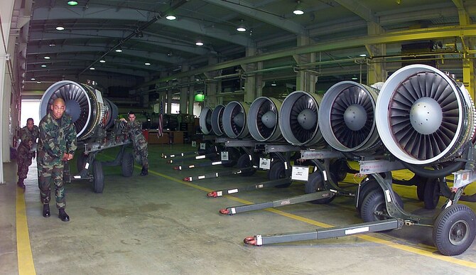 OSAN AIR BASE, South Korea -- Airmen from the 51st Maintenance Squadron's propulsion flight here move the final A-10 Thunderbolt II engine into line.  All 11 of the spare engines are mission-ready.  The airmen are (left to right)  Senior Airman Gueshuin Murray, Staff Sgt. Cedric Smith and Senior Airman John Bray.  (U.S. Air Force photo by Tech. Sgt. Alex R. Lloyd)