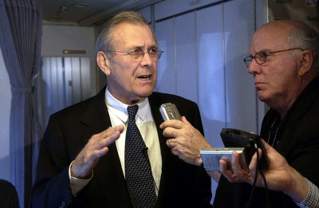 Secretary of Defense Donald H. Rumsfeld (left) answers questions from reporters traveling with him to Bogota, Colombia, on Aug. 19, 2003. Rumsfeld is en route to Bogota to meet with Colombian President Alvaro Uribe and Minister of National Defense Lucia Ramirez to discuss counter-drug and anti-guerilla efforts. 