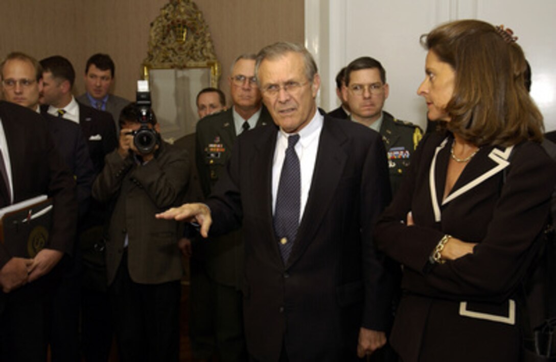 Secretary of Defense Donald H. Rumsfeld (center) responds to a reporter's question as Colombian Minister of National Defense Lucia Ramirez (right) listens in Bogota, Colombia, on Aug. 19, 2003. Rumsfeld and Ramirez will have a working lunch with Colombian President Alvaro Uribe in Bogota's Palacio Narino. Rumsfeld is in Bogota to meet with Uribe and Ramirez to discuss counter-drug and anti-guerilla efforts. 