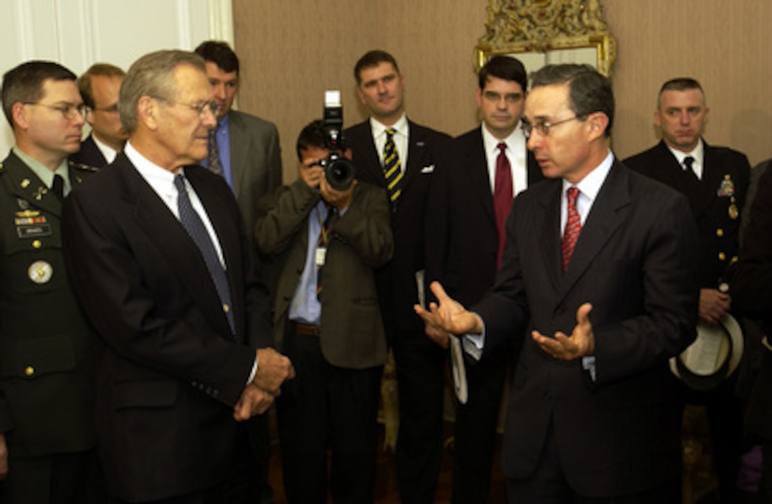 Colombian President Alvaro Uribe (right) responds to a reporter's question as Secretary of Defense Donald H. Rumsfeld (left) listens before their meeting at the Palacio Narino in Bogota, Colombia, on Aug. 19, 2003. Rumsfeld is in Bogota to meet with Uribe and Minister of National Defense Lucia Ramirez to discuss counter-drug and anti-guerilla efforts. 