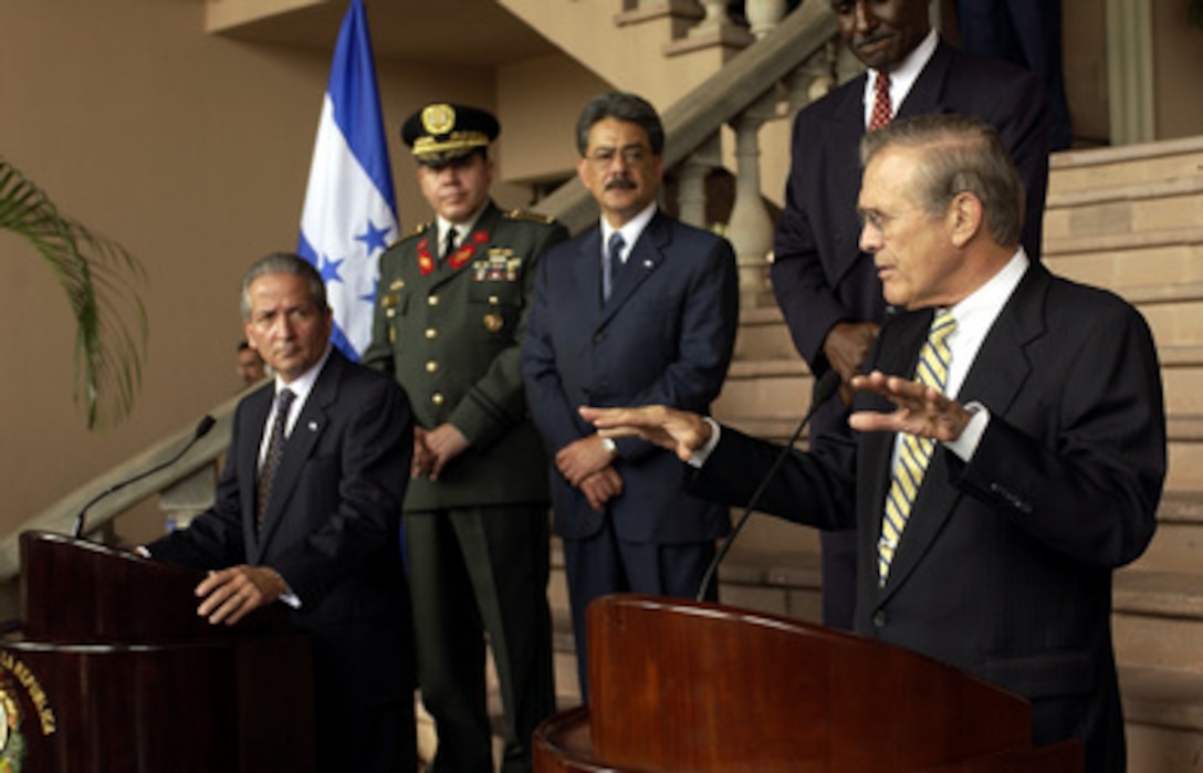 Secretary of Defense Donald H. Rumsfeld (right) answers a question from the media during a joint press conference with Honduran President Ricardo Maduro (left) at the Presidential House in Tegucigalpa, Honduras, on Aug. 20, 2003. Rumsfeld is in Honduras to meet with Maduro and to thank the Honduran government for sending troops to Iraq in support of the coalition forces. 