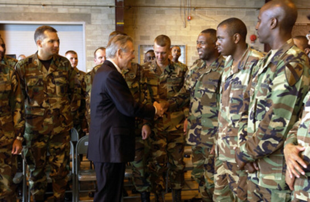 Secretary of Defense Donald H. Rumsfeld shakes hands with troops of Joint Task Force Bravo following a town hall meeting at Soto Cano Air Base, Honduras, on Aug. 20, 2003. Rumsfeld is visiting the deployed troops while in Honduras to meet with Honduran President Ricardo Maduro. The multi-service Joint Task Force Bravo trains, conducts counter-drug and humanitarian missions in Central and South America and the Caribbean. 
