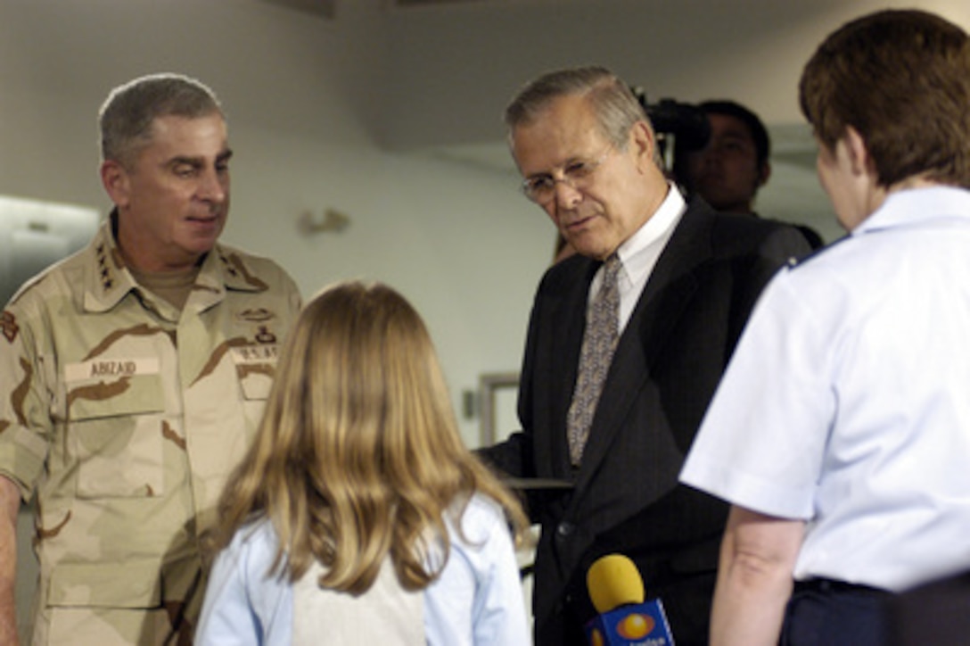 Secretary of Defense Donald H. Rumsfeld and Army Gen. John P. Abizaid, commander, U.S. Central Command, talk to Katy Hanks (center) after the DoD press briefing in the Pentagon on Aug. 21, 2003. Hanks scooped reporters in the briefing room by asking Rumsfeld what was the most unreported eventful progress in Iraq to which Abizaid said, "That's the hardest question you've gotten all day Mr. Secretary." DoD photo by R.D. Ward. (Released)