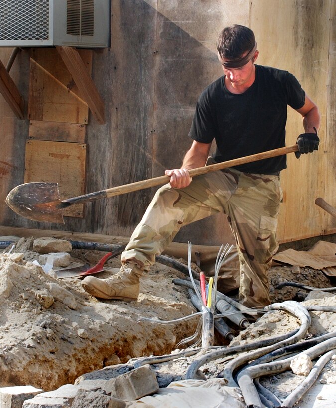 OPERATION ENDURING FREEDOM -- Senior Airman Travis Miller digs a trench for electrical cables at a forward-deployed location in Southwest Asia.  The work is part of an upgrade of the electrical system at the base. Miller is assigned to the 380th Civil Engineer Squadron and is deployed from Beale Air Force Base, Calif.  (U.S. Air Force photo by Staff Sgt. Kyle Smith)