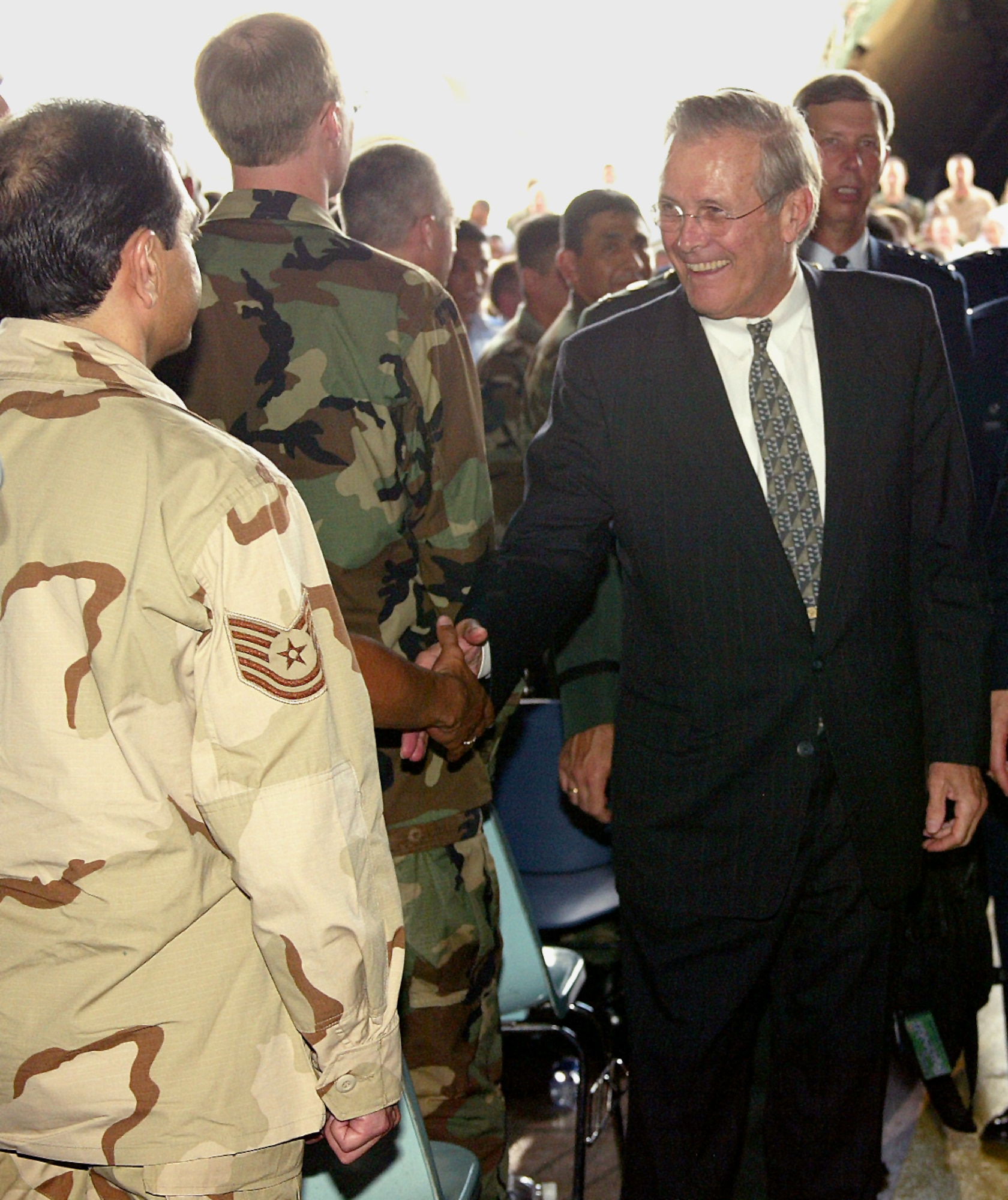 LACKLAND AIR FORCE BASE, Texas -- Secretary of Defense Donald Rumsfeld shakes hands with members of the audience after a town hall meeting here Aug. 25.  He spoke to about 3,500 servicemembers from installations in the San Antonio area.  (U.S. Air Force photo by Robbin Cresswell)