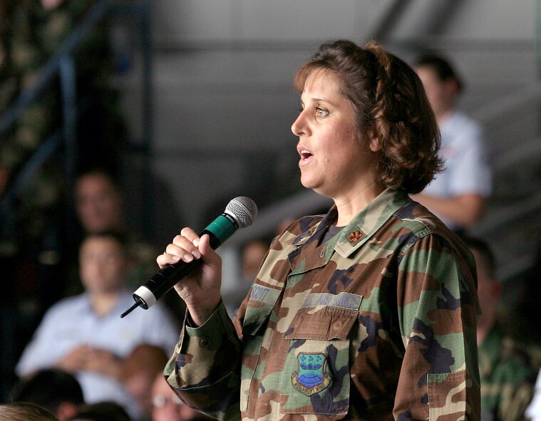 LACKLAND AIR FORCE BASE, Texas -- Maj. Michaelene Scott asks Secretary of Defense Donald Rumsfeld a question during a town hall meeting here Aug. 25.  Rumsfeld addressed about 3,500 servicemembers from installations in the San Antonio area.  Scott is a reservist assigned to 433rd Logistics Readiness Squadron.  (U.S. Air Force photo by Robbin Cresswell)