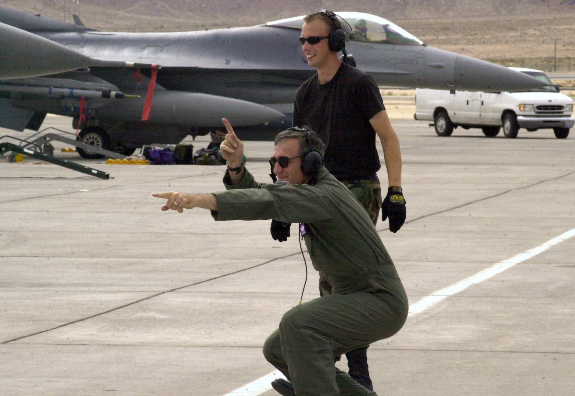 NELLIS AIR FORCE BASE, Nev. -- Brig. Gen. Michael Worden marshals an F-16 Fighting Falcon here while crew chief Staff Sgt. Aaron M. Hudson supervises.  Worden commands the 31st Fighter Wing at Aviano Air Base, Italy, and Hudson is assigned to the 31st Aircraft Maintenance Squadron.  The airmen are participating in a Red Flag exercise which ends Aug. 29.  (U.S. Air Force photo by Senior Airman Lakisha Croley)
