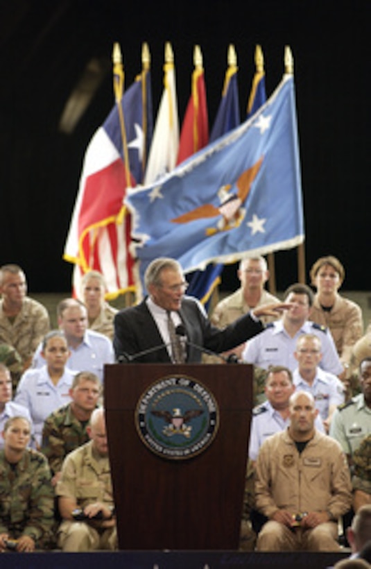 Secretary of Defense Donald H. Rumsfeld gestures to make a point as he answers a question from a member of the audience during a town hall meeting at Lackland Air Force Base, San Antonio, Texas, on Aug. 25, 2003. Rumsfeld delivered his opening remarks then fielded questions from military and civilian attendees. Many of the service men and women behind Rumsfeld are veterans of Operation Enduring Freedom and Operation Iraqi Freedom. 