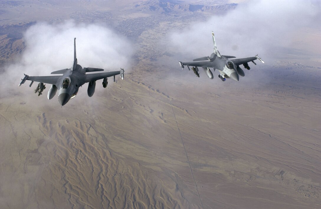 OVER AFGHANISTAN -- A pair of F-16 Fighting Falcons fly a patrol mission while supporting Operation Enduring Freedom on Nov. 29.  The aircraft are from the New York Air National Guard's 174th Fighter Wing at Syracuse.  (U.S. Air Force photo by Staff Sgt. Suzanne M. Jenkins)