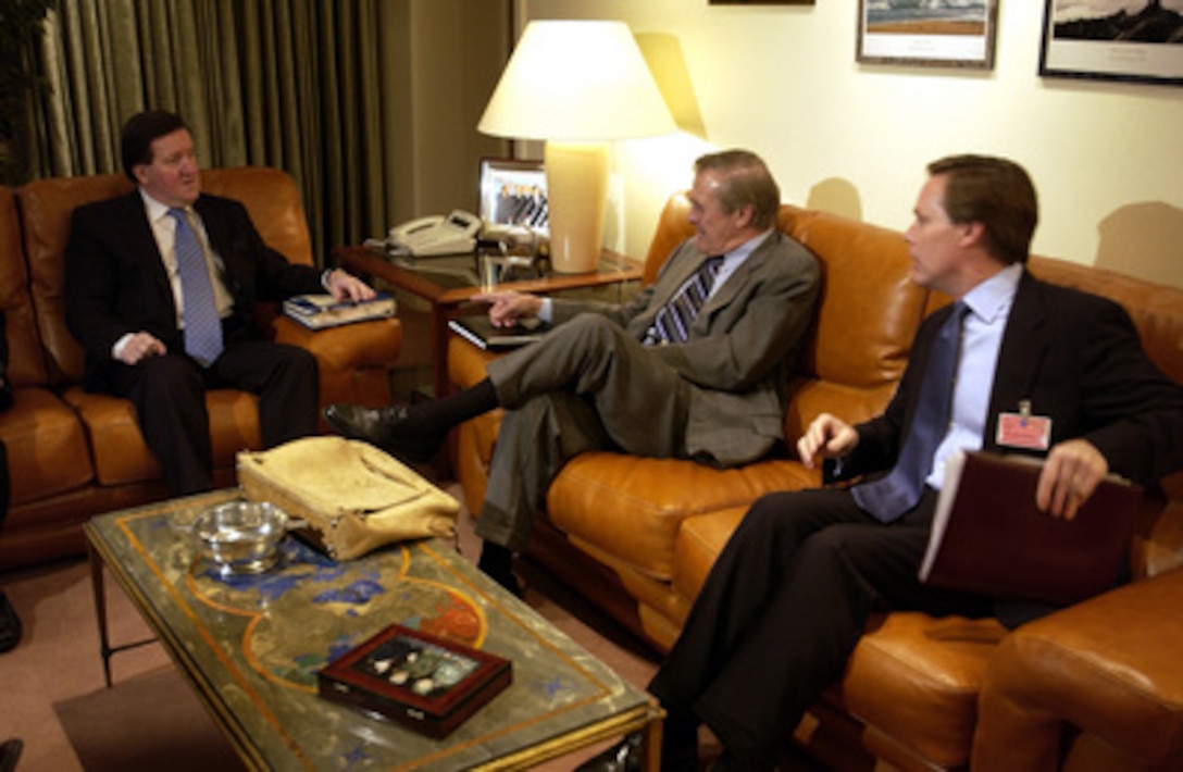 Secretary of Defense Donald H. Rumsfeld (center) speaks with NATO Secretary General Lord George Robertson (left) in Brussels, Belgium, on Dec. 1, 2003. Rumsfeld is at NATO headquarters for a two-day meeting of allied defense ministers to discuss expanding NATO's mission. U.S. Ambassador to NATO R. Nicholas Burns joined Rumsfeld and Roberts for their informal meeting. 