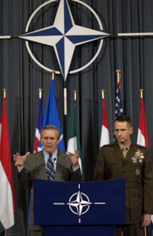 Secretary of Defense Donald H. Rumsfeld responds to a reporter's question during a press conference at NATO headquarters in Brussels, Belgium, on Dec. 1, 2003. Rumsfeld and Vice Chairman of the Joint Chiefs of Staff Gen. Peter Pace, U.S. Marine Corps, gave reporters an update on the progress of the NATO meetings. Rumsfeld is at NATO headquarters for a two-day meeting of allied defense ministers to discuss expanding NATO's mission. 