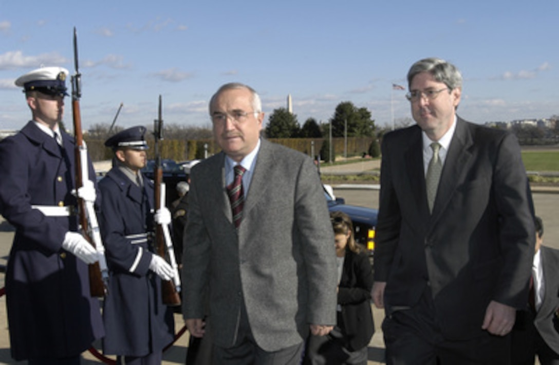 Under Secretary of Defense Douglas Feith (right) escorts Turkish Minister of Justice Cemil Cicek into the Pentagon on Dec. 2, 2003. Cicek will meet with Feith and Deputy Secretary of Defense Paul Wolfowitz to discuss issues relating to the war on terrorism. 
