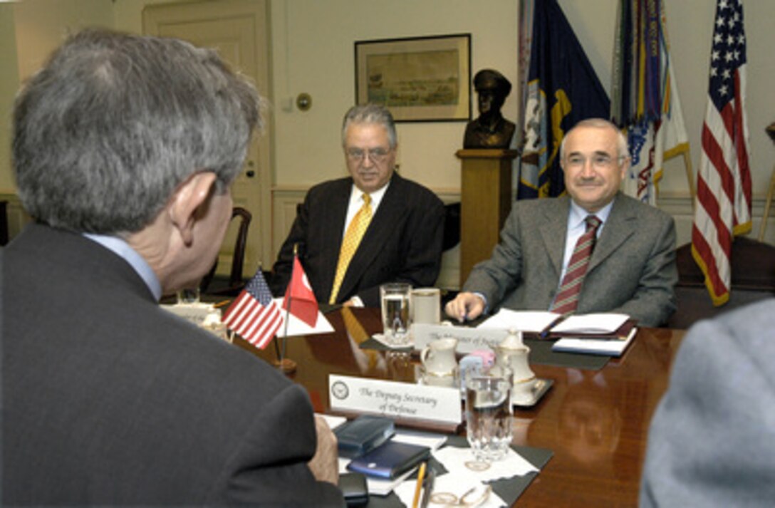Turkish Minister of Justice Cemil Cicek (right) meets with Deputy Secretary of Defense Paul Wolfowitz (foreground) in the Pentagon on Dec. 2, 2003, to discuss various issues relating to the global war on terrorism. Also participating in the talks is Turkish Ambassador to the United States Osman Faruk Logoglu (center). 
