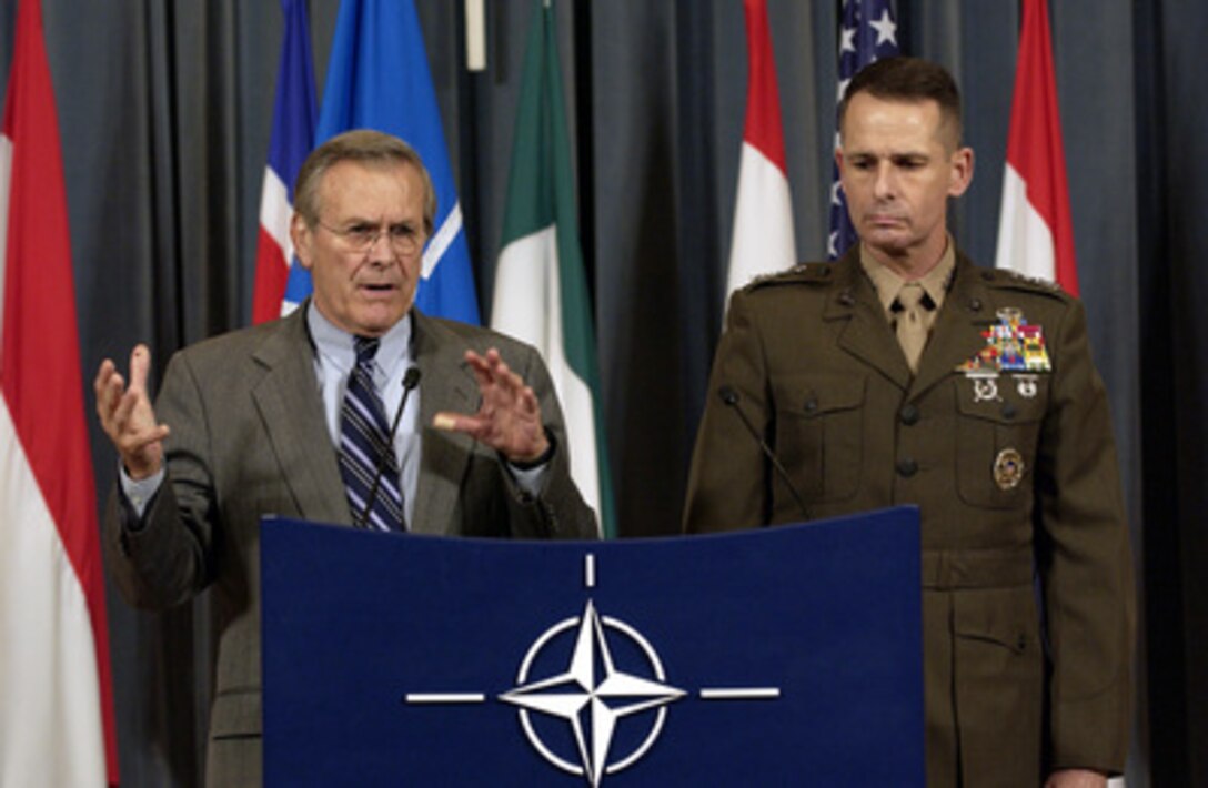 Secretary of Defense Donald H. Rumsfeld responds to a reporter's question during a press conference at NATO headquarters in Brussels, Belgium, on Dec. 1, 2003. Rumsfeld and Vice Chairman of the Joint Chiefs of Staff Gen. Peter Pace, U.S. Marine Corps, gave reporters an update on the progress of the NATO meetings. Rumsfeld is at NATO headquarters for a two-day meeting of allied defense ministers to discuss expanding NATO's mission. 
