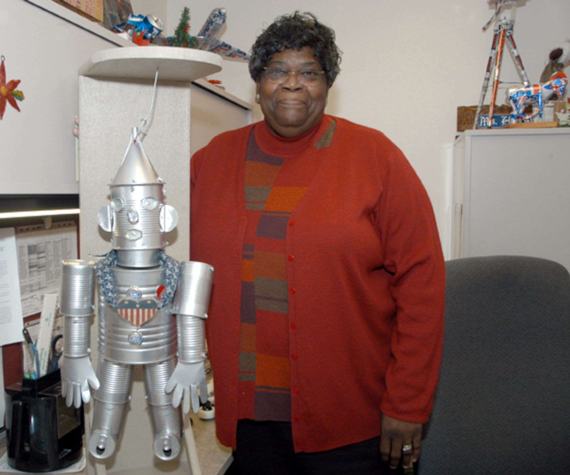 ANDREWS AIR FORCE BASE, Md. -- Helen Walker displays a true tin man, her favorite personal can creation.  Walker uses all types of cans and recycled materials to create a variety of sculptures.  She is the 89th Civil Engineer Squadron's maintenance flight quality assurance evaluator.  (U.S. Air Force photo by Bobby Jones)