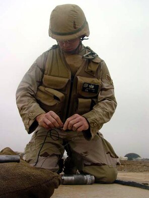 TALLIL AIR BASE, Iraq -- Senior Airman Dustin Heines, an explosive ordnance disposal technician, prepares to disarm an unexploded munition.  Heines is assigned to the 332nd Expeditionary Civil Engineer Squadron's EOD flight, and is deployed from McGuire Air Force Base, N.J.  (U.S. Air Force photo by Staff Sgt. Chris Stagner)