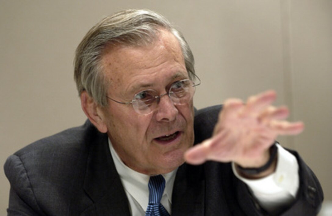 Secretary of Defense Donald H. Rumsfeld talks to reporters during a regional press roundtable in Brussels, Belgium, on Dec. 2, 2003. Rumsfeld and U.S. Ambassador to NATO R. Nicholas Burns briefed on the NATO talks and Operation Iraqi Freedom. Rumsfeld is at NATO headquarters for a two-day meeting of allied defense ministers to discuss expanding NATO's mission. 