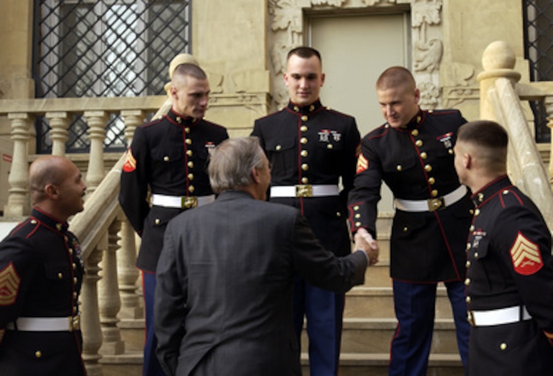 Secretary of Defense Donald H. Rumsfeld shakes hands with U.S. Marines stationed at the U.S. Embassy in Baku, Azerbaijan, on Dec. 3, 2003. Rumsfeld is in Baku for bilateral talks with President Ilham Aliyev and Defense Minister Col. Gen. Safar Abiyev. 