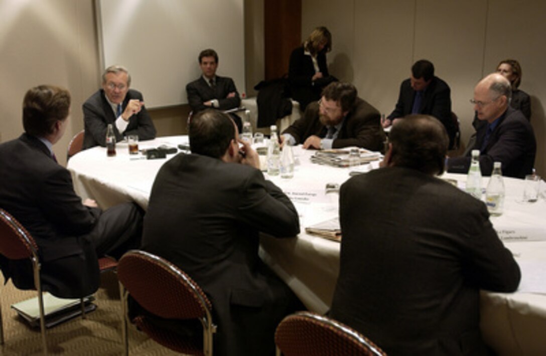 Secretary of Defense Donald H. Rumsfeld (left) talks to reporters during a regional press roundtable in Brussels, Belgium, on Dec. 2, 2003. Rumsfeld and U.S. Ambassador to NATO R. Nicholas Burns briefed reporters on the NATO talks and Operation Iraqi Freedom. Rumsfeld is at NATO headquarters for a two-day meeting of allied defense ministers to discuss expanding NATO's mission. 