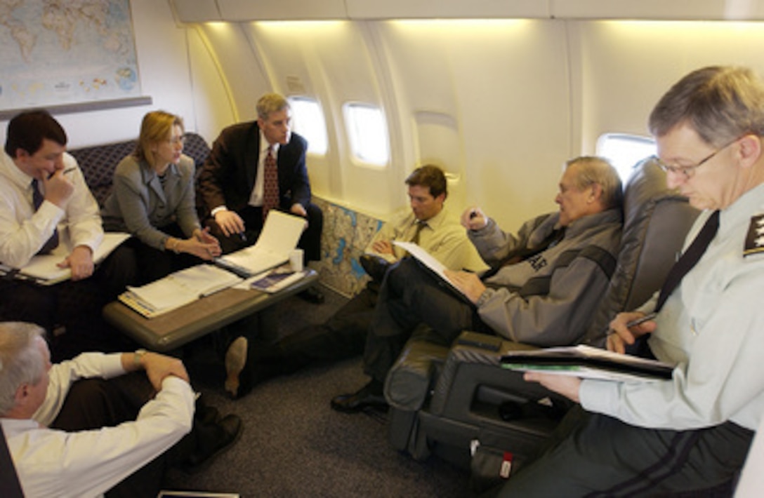 Secretary of Defense Donald H. Rumsfeld (seated right) briefs with his senior staff while en route to Baku, Azerbaijan, on Dec. 3, 2003. Rumsfeld is traveling to Baku for bilateral talks with President Ilham Aliyev and Defense Minister Col. Gen. Safar Abiyev. 