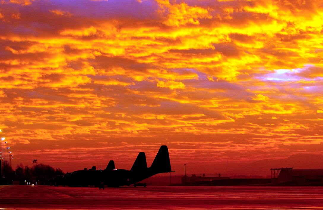 RAMSTEIN AIR BASE, Germany -- The sun rises and seems to set the sky on fire as several C-130 Hercules sit on the ramp here. (U.S. Air Force photo by Tech. Sgt. Justin D. Pyle)
