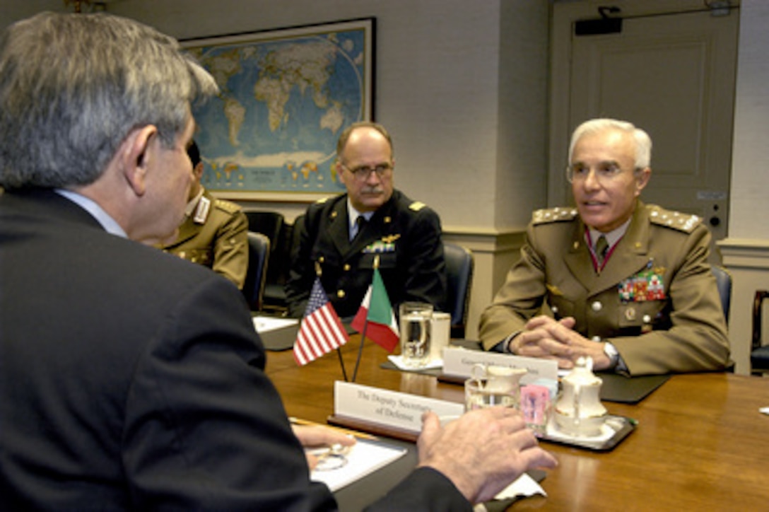 Chief of the Italian Defense Staff Gen. Rolando Mosca Moschini (right) meets with Deputy Secretary of Defense Paul Wolfowitz (foreground) in the Pentagon on Dec. 4, 2003. Moschini and Wolfowitz, along with a small number of their senior advisors, are meeting to discuss a range of security issues of mutual interest. Italy has been a strong member of the coalition in the reconstruction of Iraq, sending 2,500 troops to help maintain law and order. 