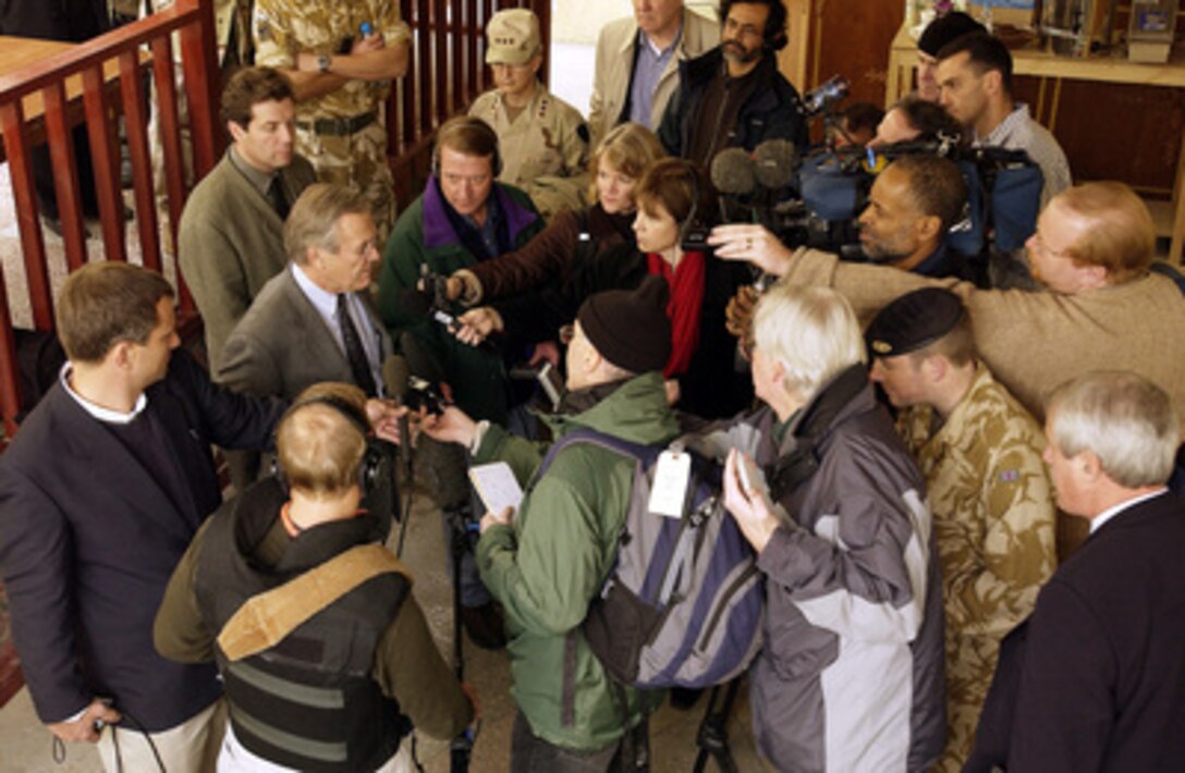 Reporters surround Secretary of Defense Donald H. Rumsfeld as he answers a question during an informal press conference in Mazar-e-Sharif, Afghanistan, on Dec. 4, 2003. Rumsfeld is in Afghanistan to meet with President Hamid Karzai and U.S troops deployed there. 