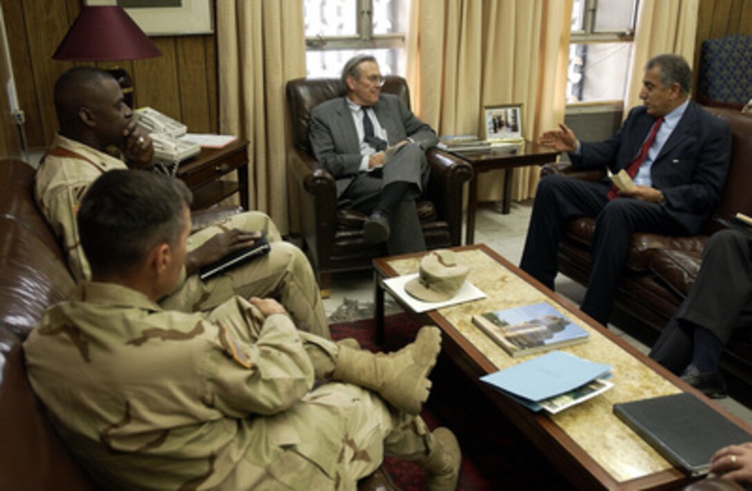 Army Lt. Gen. David Barno (foreground), Gen. Lloyd Austin (left), Secretary of Defense Donald H. Rumsfeld (center) and U.S. Ambassador Zalmay M. Khalilzad discuss the current situation in Afghanistan during a meeting in Kabul on Dec. 4, 2003. Rumsfeld is in Afghanistan to meet with President Hamid Karzai and U.S troops deployed there. 