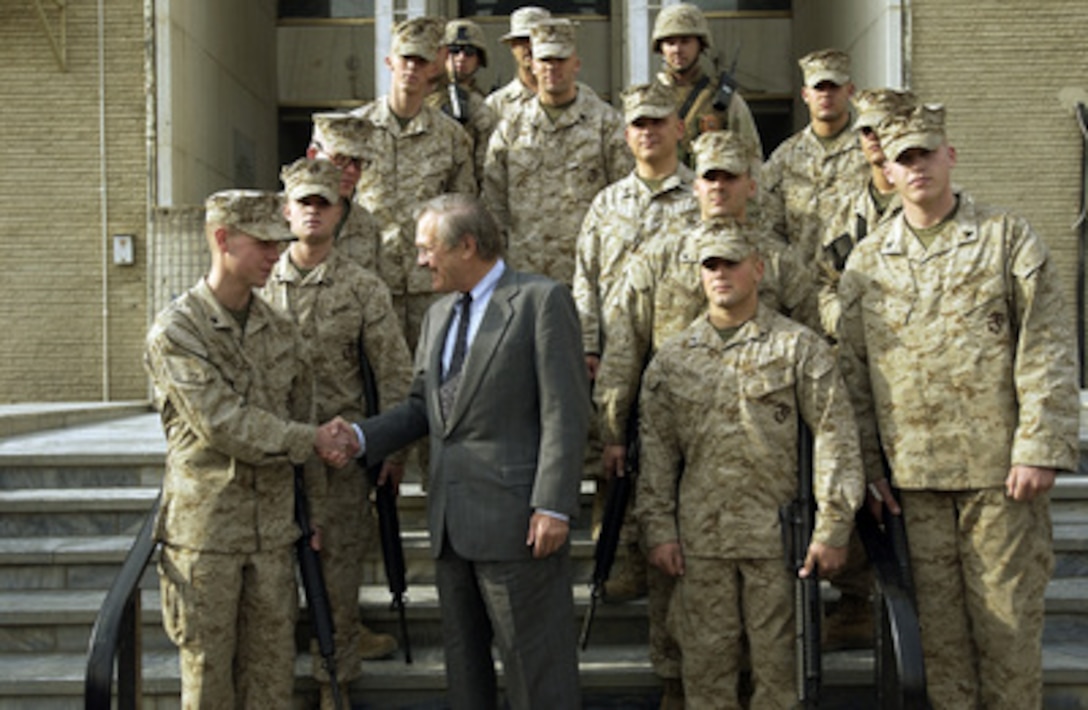 Secretary of Defense Donald H. Rumsfeld shakes hands with U.S. Marines at the U.S. Embassy in Kabul, Afghanistan, on Dec. 4, 2003. Rumsfeld is in Afghanistan to meet with President Hamid Karzai and U.S troops deployed there. 