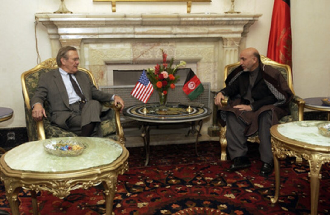 Secretary of Defense Donald H. Rumsfeld (left) speaks with Afghanistan's President Hamid Karzai in Kabul, Afghanistan, on Dec. 4, 2003. Rumsfeld is in Afghanistan to meet with Karzai and U.S troops deployed there. 
