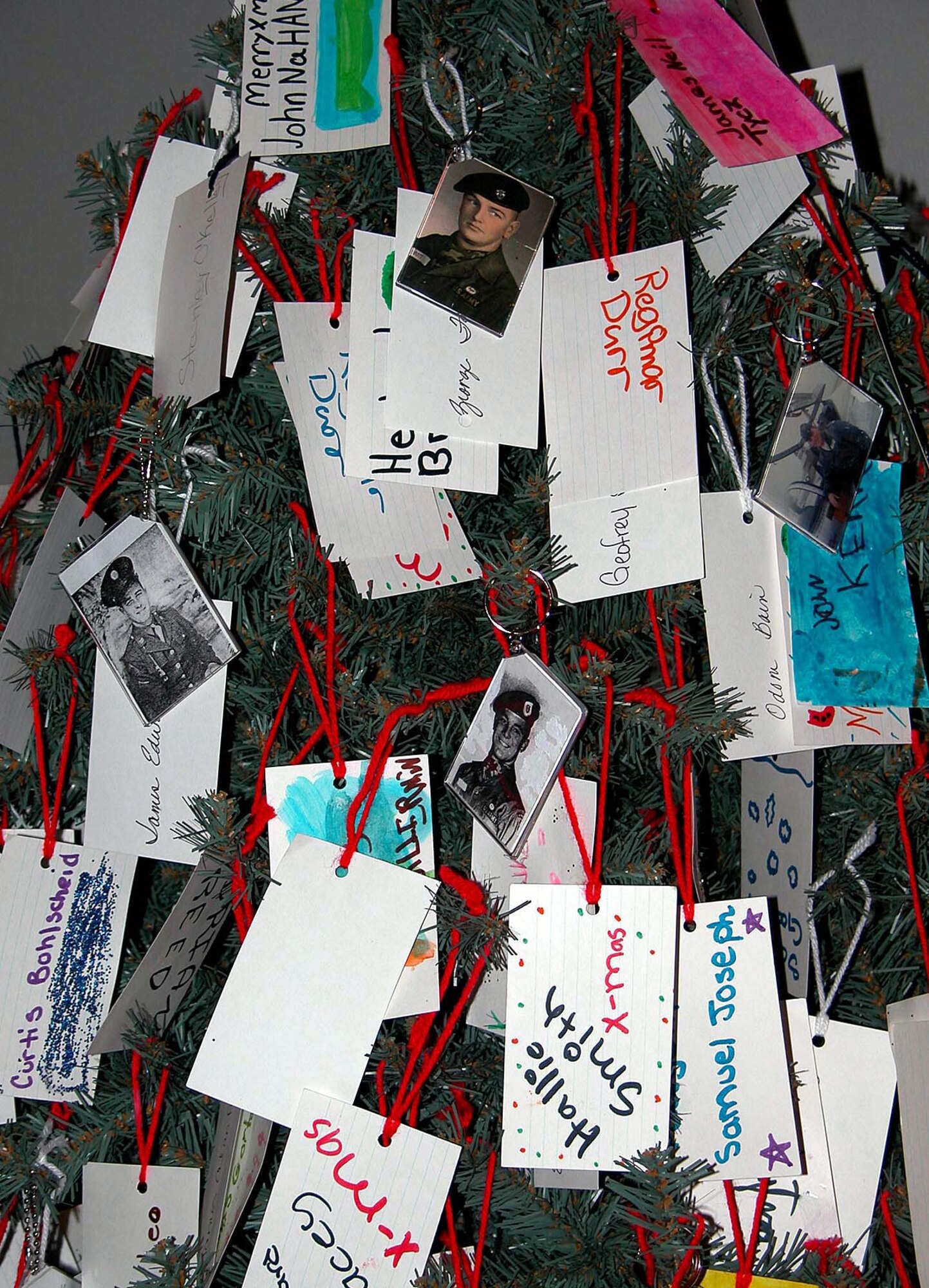 WASHINGTON -- This year's POW/MIA holiday tree includes pictures of about 10 missing servicemen.  Retired Army Master Sgt. Peggy Marish-Boos started the POW/MIA holiday tree tradition in 1998.  (Department of Defense photo by Rudi Williams)
