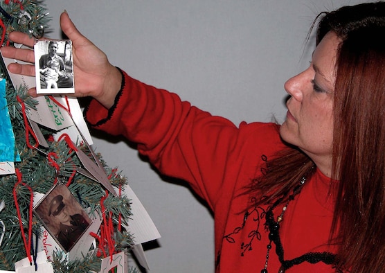 WASHINGTON -- Retired Army Master Sgt. Peggy Marish-Boos, creator of the POW/MIA holiday tree, holds a picture of Army Cpl. Samuel C. "Sam Jr." Harris who was lost during the Korean War on Nov. 27, 1950.  In the photo, 14-year-old Harris is shown holding his younger sister, Barbara Ann Harris, then 2.  (Department of Defense photo by Rudi Williams)