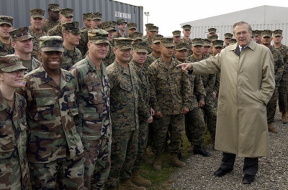 Secretary of Defense Donald H. Rumsfeld points out a U.S. Marine as he talks with the Marines and Army soldiers deployed to Kritsanisi, Georgia, on Dec. 5, 2003. Rumsfeld is in Georgia to meet with Acting President Nino Burjanadze, Minister of Defense Gen. David Tevzadze and to visit with U.S. troops deployed there. 