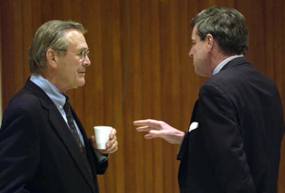 Ambassador Paul Bremer (right) tells Secretary of Defense Donald H. Rumsfeld about the progress of Operation Iraqi Freedom at the Baghdad International Airport, Baghdad, Iraq, on Dec. 6, 2003. Rumsfeld is in Iraq to meet with members of the Coalition Provisional Authority, senior military leaders and the troops deployed there. 