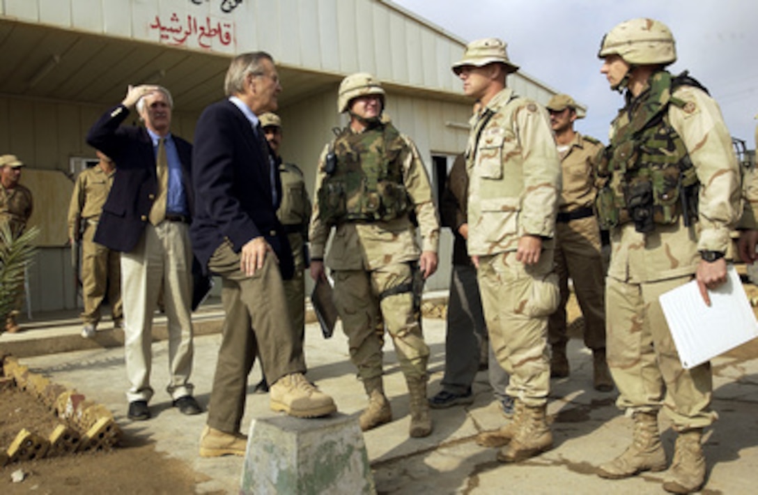 Secretary of Defense Donald H. Rumsfeld is briefed on the Iraqi Civil Defense Corps training by Army Sgt. Kearney in Baghdad, Iraq, on Dec. 6, 2003. Rumsfeld is in Iraq to meet with members of the Coalition Provisional Authority, senior military leaders and the troops deployed there. 