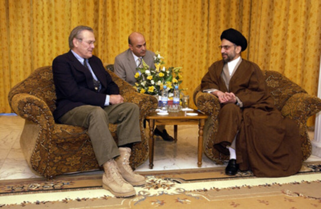 Secretary of Defense Donald H. Rumsfeld meets with Iraq Governing Council President Abdel Aziz Hakim in Baghdad, Iraq, on Dec. 6, 2003. Rumsfeld is in Iraq to meet with members of the Coalition Provisional Authority, senior military leaders and the troops deployed there. 