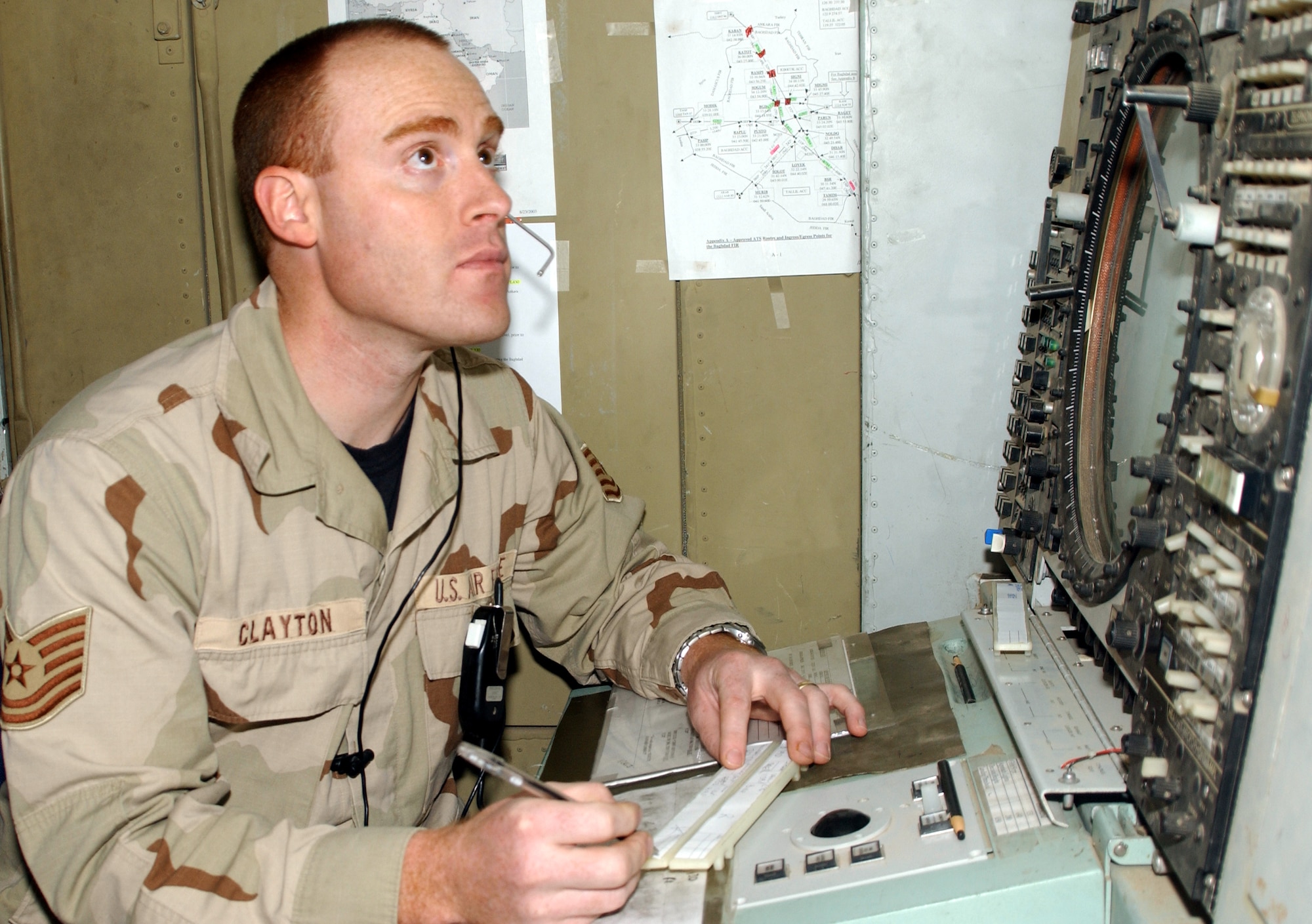 KIRKUK AIR BASE, Iraq -- Tech. Sgt. Kevin Clayton monitors aircraft traffic from his position in the center radar approach control facility.  The controllers are responsible for air traffic throughout northern Iraq.  (U.S. Air Force photo by Airman 1st Class Alicia Sarkkinen)