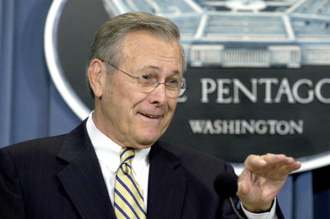 Secretary of Defense Donald H. Rumsfeld tells reporters about some of the logistical complexity of the upcoming U.S. troop rotations into and out of Afghanistan and Iraq during a Pentagon press briefing on Dec. 9, 2003. Rumsfeld and Chairman of the Joint Chiefs of Staff Gen. Richard B. Myers, U.S. Air Force, updated reporters on the progress of the Iraqi security forces training and the coalitions' efforts in Iraq. 