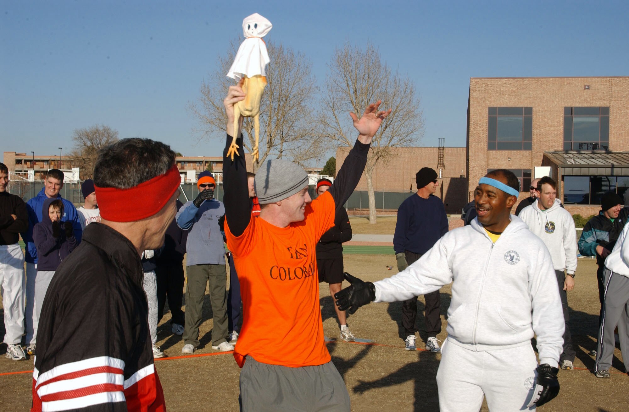 PETERSON AIR FORCE BASE, Colo. -- Second Lt. Luke Grogan celebrates winning the last place rubber chicken award during a group fitness competition.  Space and Missile Systems Center Detachment 11 and Electronic Systems Center Detachment 5 airmen designed a course that took teams around Peterson to compete in a wide variety of challenges.  Six teams participated in the race based on the television reality show, "The Amazing Race."  (U.S. Air Force photo by Staff Sgt. Josh Clendenen)