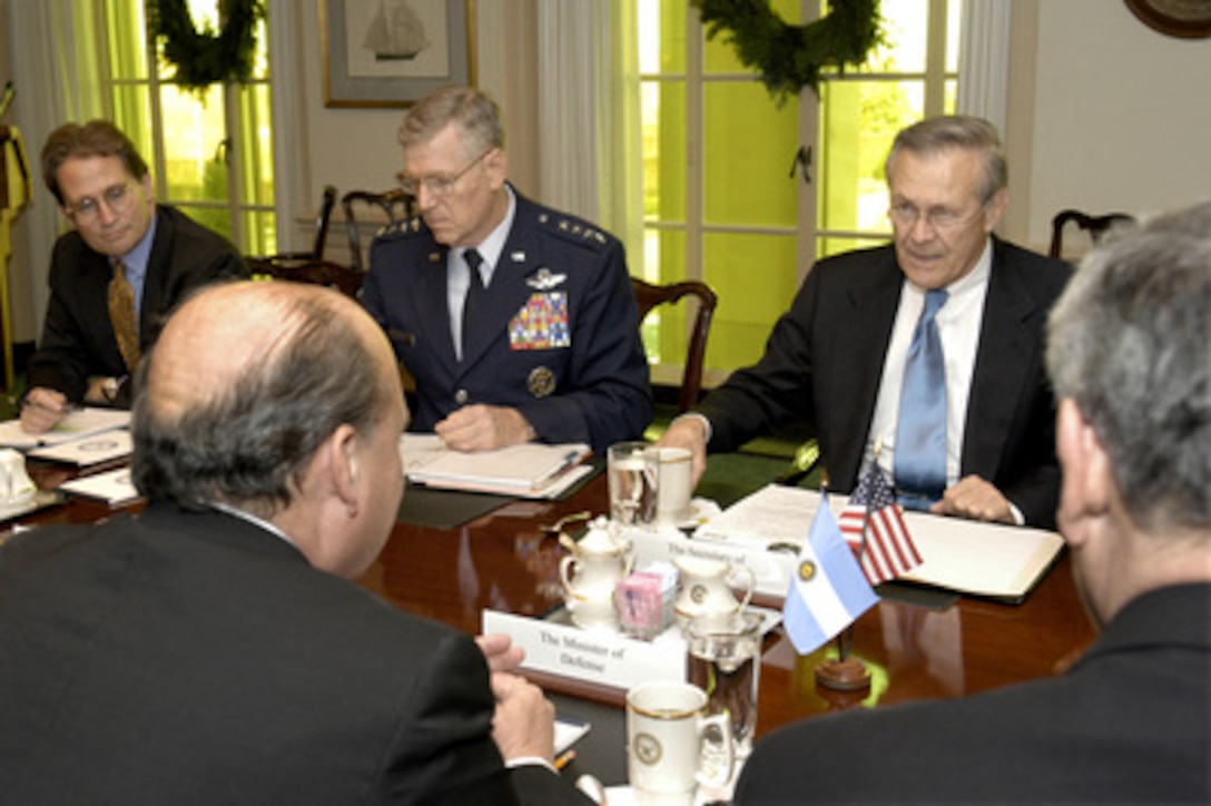 Secretary of Defense Donald H. Rumsfeld (right, far-side of the table) hosts a meeting in the Pentagon on Dec. 11, 2003, with Minister of Defense Jose Pampuro (foreground) of the Argentine Republic. A broad range of bilateral security issues, both regional and global, are being discussed. Joining Rumsfeld for the talks are Peter Flory left), the principal deputy assistant secretary of defense for international security affairs, and Gen. Richard B. Myers (center), U.S. Air Force, the chairman of the Joint Chiefs of Staff. 