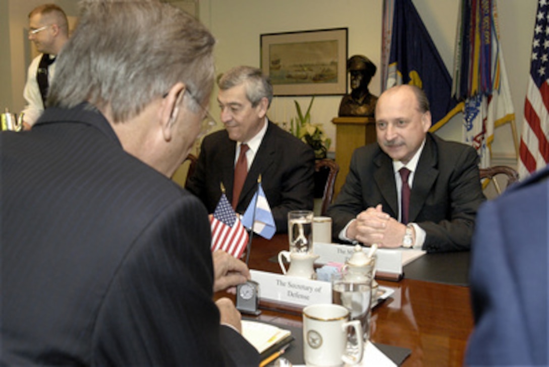 Argentine Minister of Defense Jose Pampuro (right) meets with Secretary of Defense Donald H. Rumsfeld in the Pentagon on December 11, 2003. A broad range of bilateral security issues, both regional and global, are being discussed. Also participating in the talks is Argentine Ambassador to the United States Jose Octavio Bordon (center). 