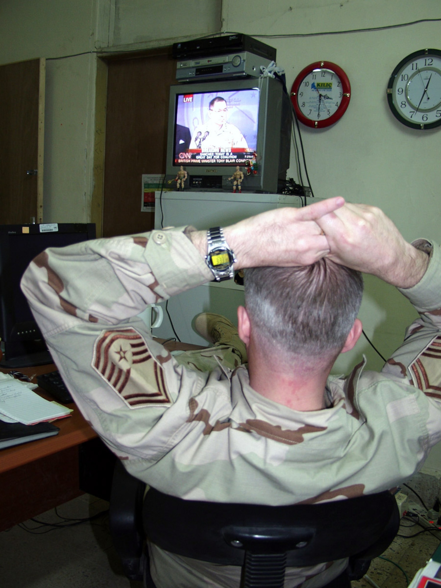 KIRKUK AIR BASE, Iraq -- Senior Master Sgt. Eugene LaDoucer watches as Lt. Gen. Richardo Sanchez conducts a press conference.  Sanchez announced the capture of Saddam Hussein on Dec. 14.  LaDoucer is assigned to the 506th Air Expeditionary Group public affairs here.  (U.S. Air Force photo by Tech. Sgt. Jeffrey Williams)