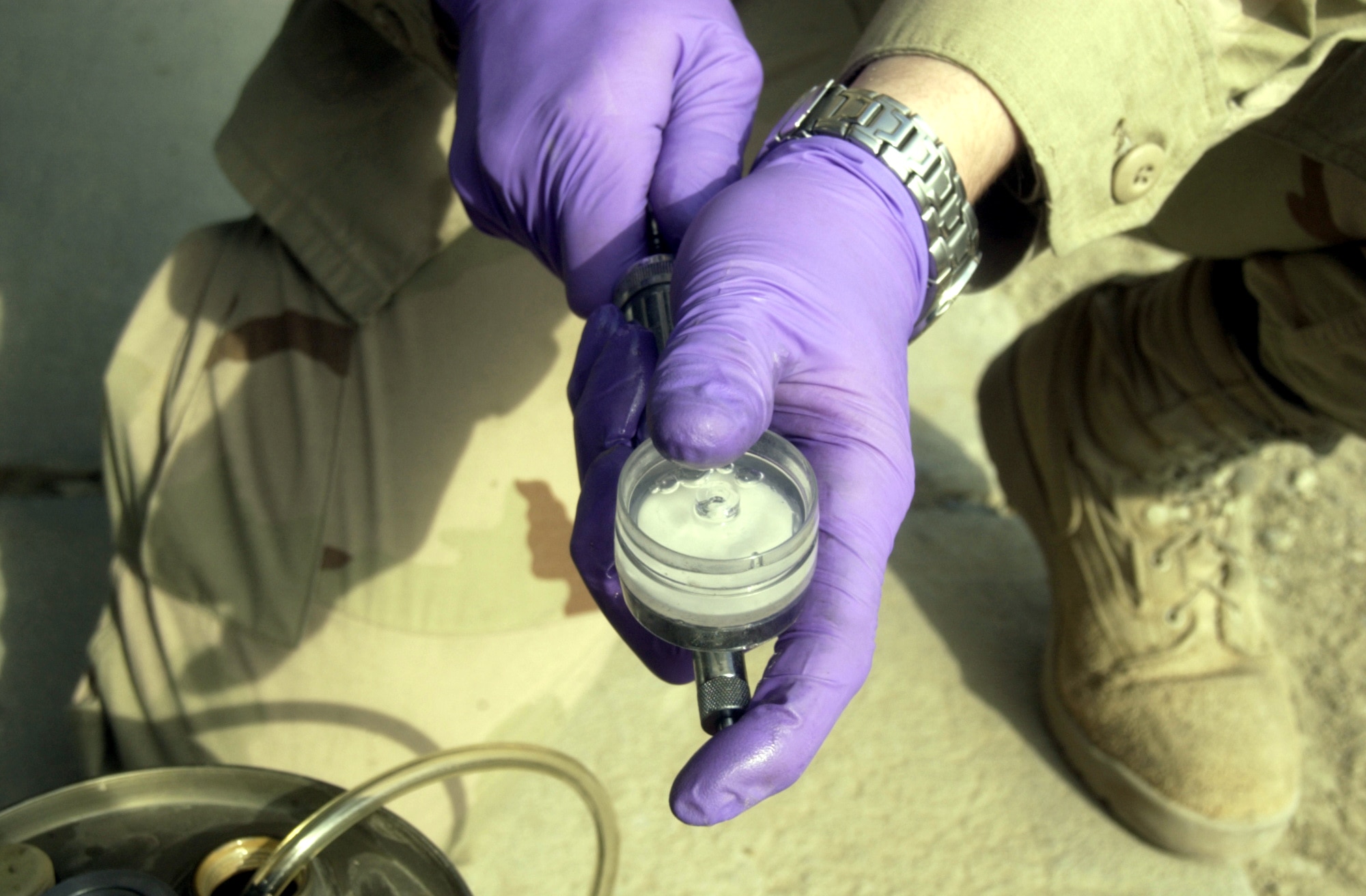 BAGRAM AIR BASE, Afghanistan -- Staff Sgt. Robert Armentrout checks for contamination in a jet fuel sample.  He is a fuels specialist assigned to the 455th Expeditionary Operations Group.  (U.S. Air Force photo by Tech. Sgt. Brian Davidson)