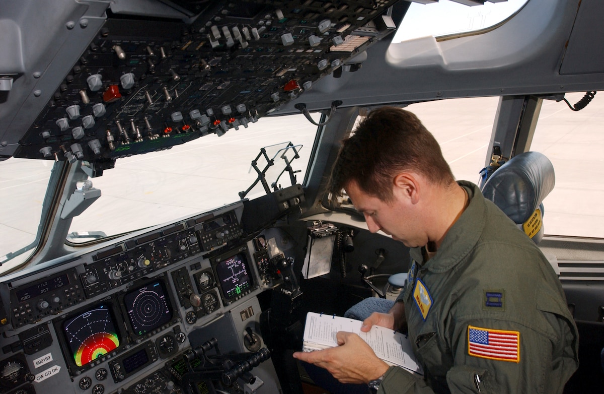 NELLIS AIR FORCE BASE, Nev. -- Capt. Brian Wald reviews his preflight checklists before flying a C-17 Globemaster III during a mission-employment exercise here Dec. 10.  This is the first year a C-17 has been included in the exercise.  Wald is a student in the first C-17 Weapons Instructor Course.  (U.S. Air Force photo by Tech. Sgt. Kevin Gruenwald)